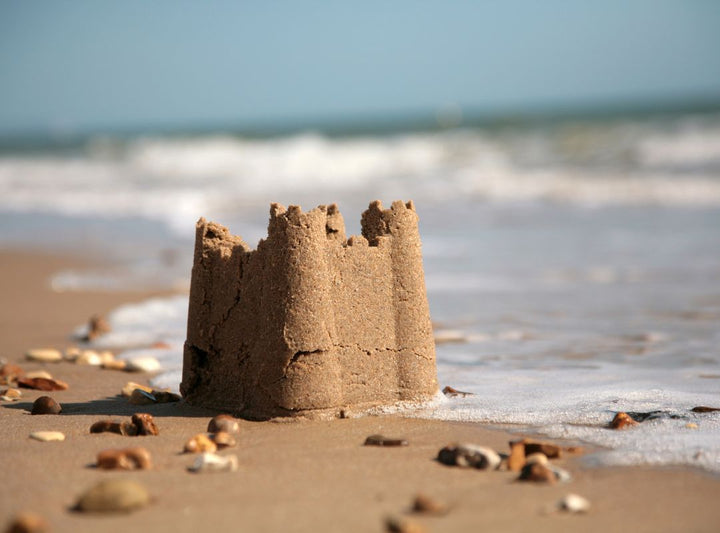 There is a sand castle on the beach.